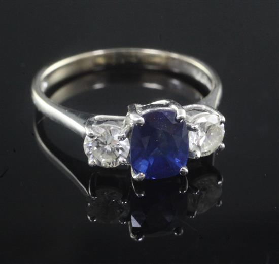 A modern 18ct white gold and three stone diamond and sapphire ring, size J.